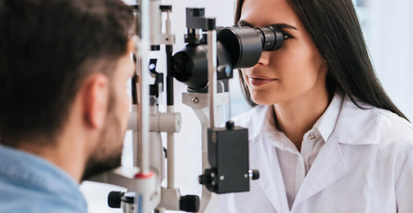 Women giving man an eye exam